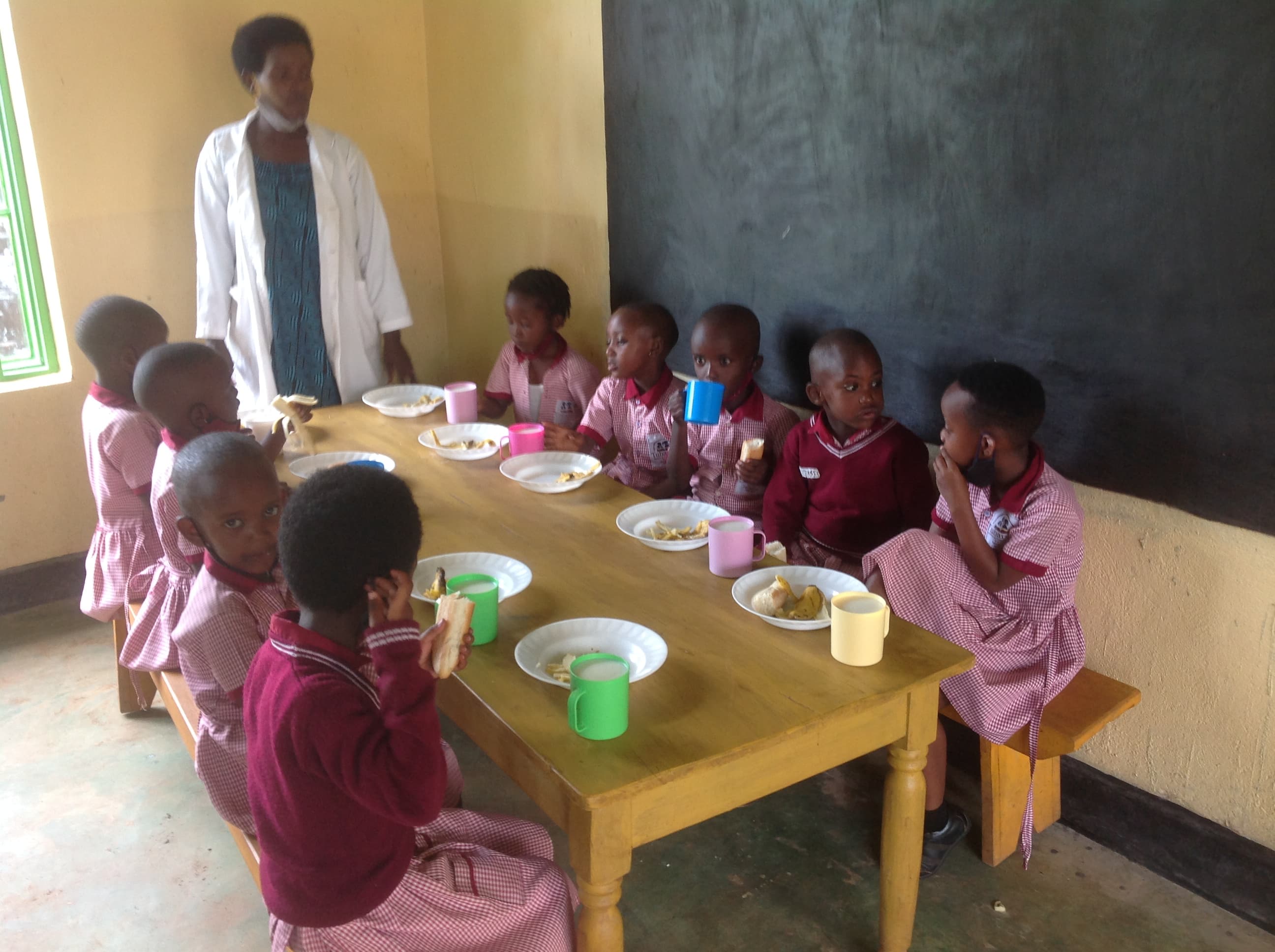 Nursery children having breakfast at school